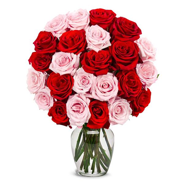 There are pink, red roses and greens in a glass vase. The pink rose may not be in stock. DIFFERENT COLOR IS USED